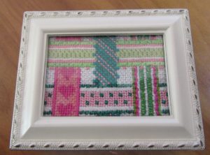 pink and green woven ribbons needlepoint by Kate Dickerson