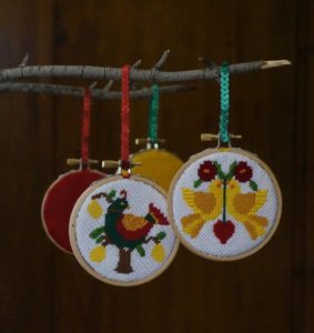 12 Days needlepoint ornaments finished in wood embroidery hoops