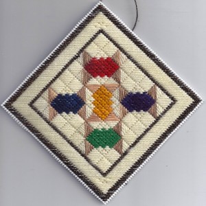 Plastic Canvas Needlepoint Spool Quilt Ornament, designed by needlepoint expert Janet M. Perry