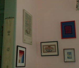 gallery wall of framed and mated needlepoint
