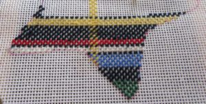 close-up of partially stitched needlepoint plaid