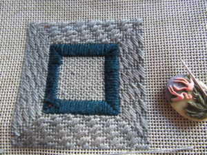 mitered needlepoint border of diagonal stitches