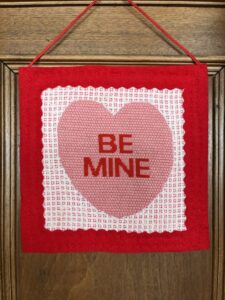 needlepoint heart with pulled thread bacground